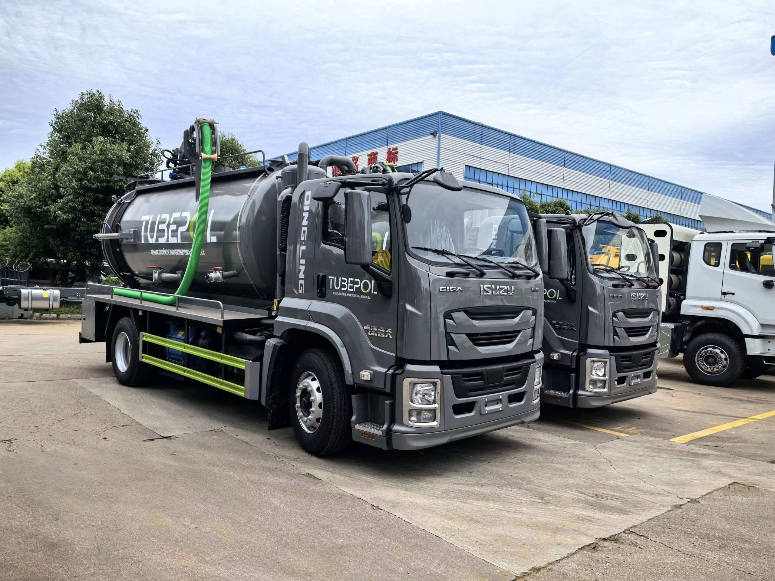 Isuzu black and green vacuum system trucks ready for export final check